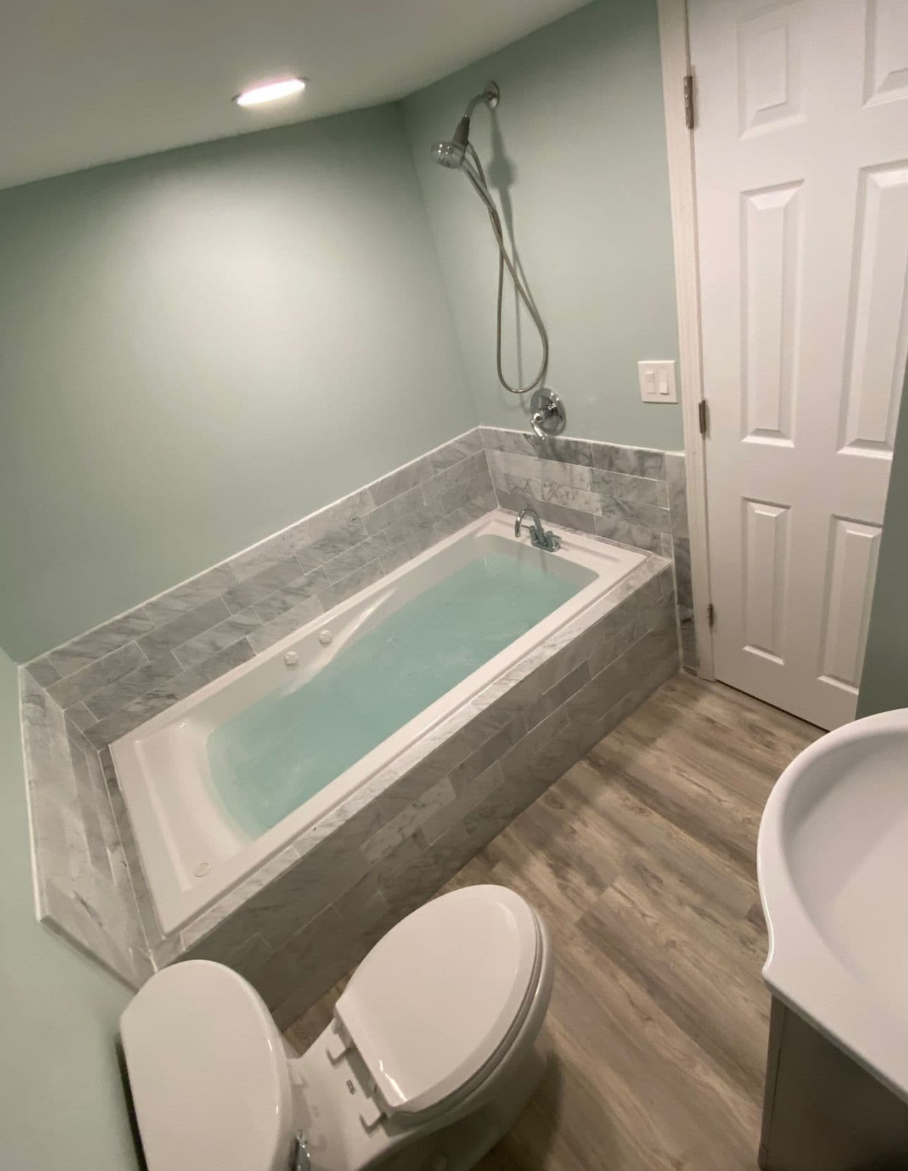 Bathroom remodel with marble jacuzzi tub and wood floor in North Port FL