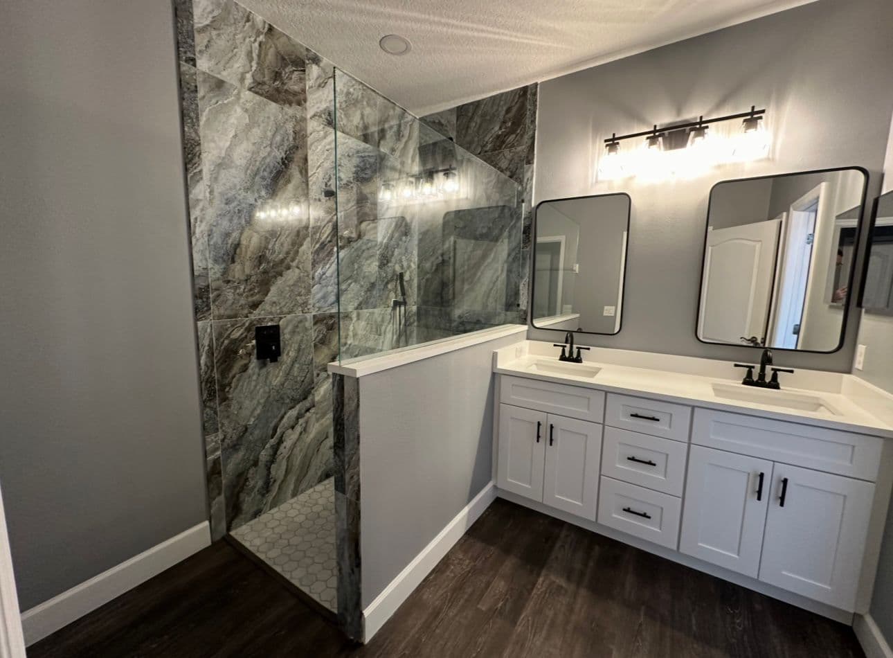Bathroom remodel with walk-in shower marble tile and double vanity in North Port FL