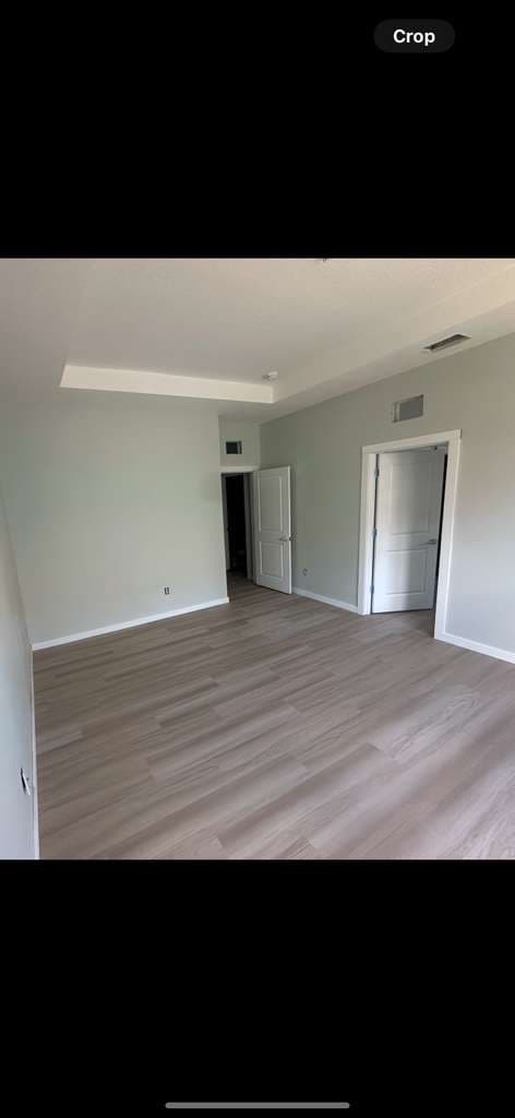Bedroom remodel with wood look flooring and light green walls in North Port FL