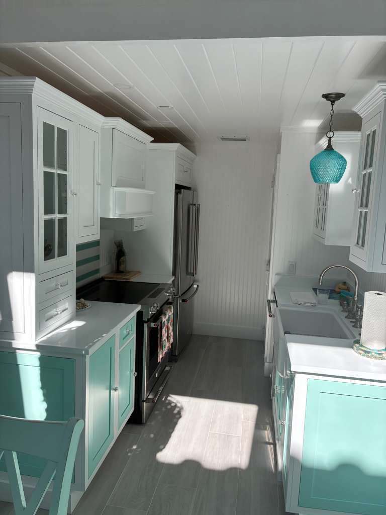 Kitchen remodel with aqua cabinets and white countertops in North Port FL
