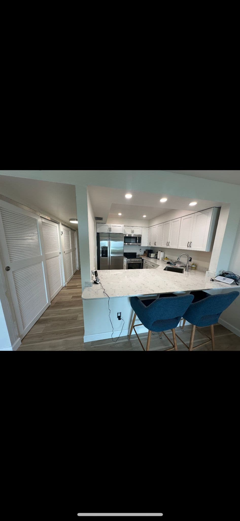 Kitchen remodel with white cabinets and breakfast bar in North Port FL