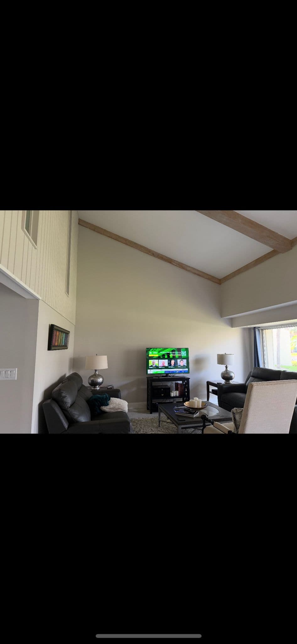 Living room remodel with gray furniture and wood beam ceiling in North Port FL