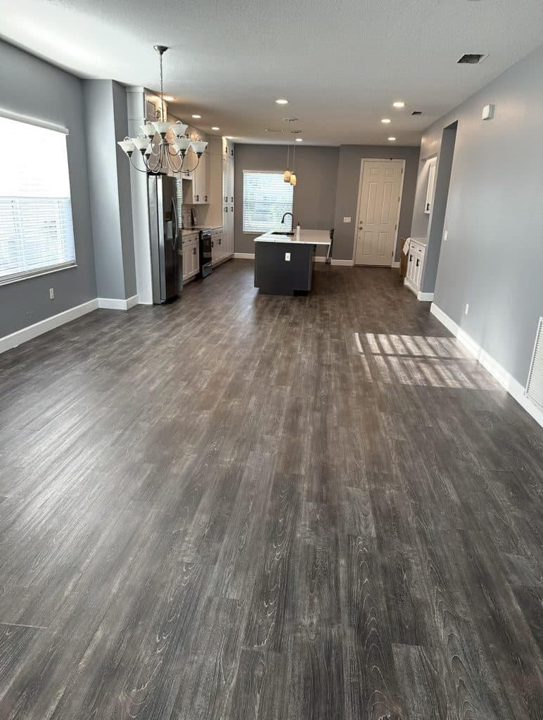 Open concept living and kitchen area with new luxury vinyl plank flooring